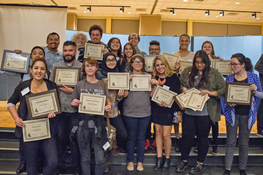 student journalists and faculty members pose with awards after a journalism conference recognition event