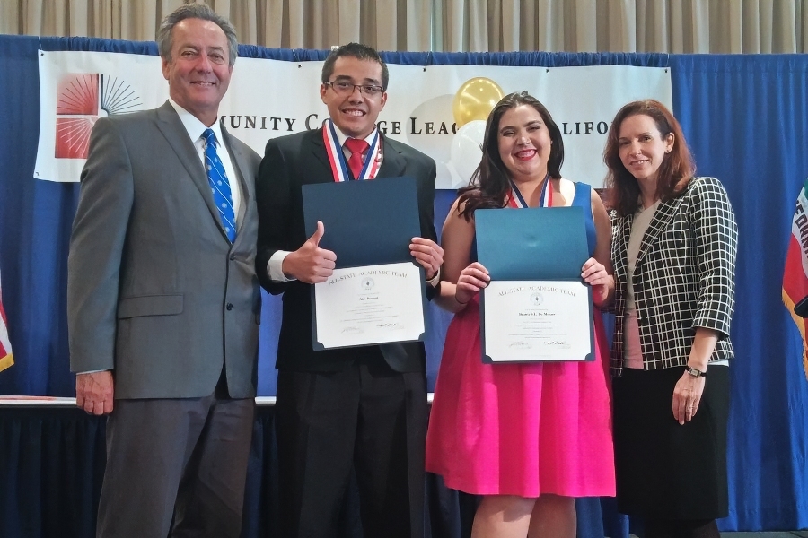 alex bazaar and beatriz santos hold all california academic team certificates and wear medals while posing with citrus college representatives at the community college league of california ceremony