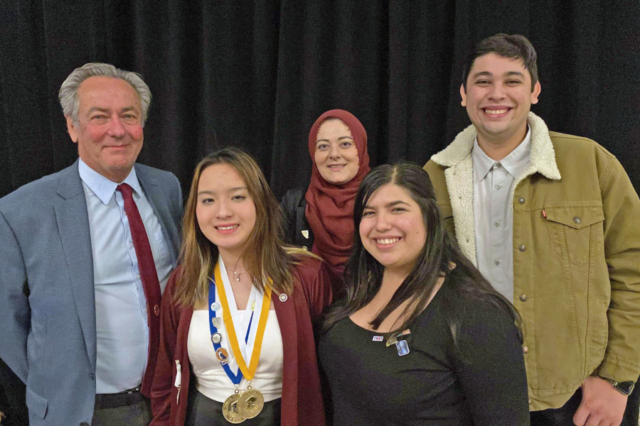 group of Phi Theta Kappa students and advisers posing together after an awards convention
