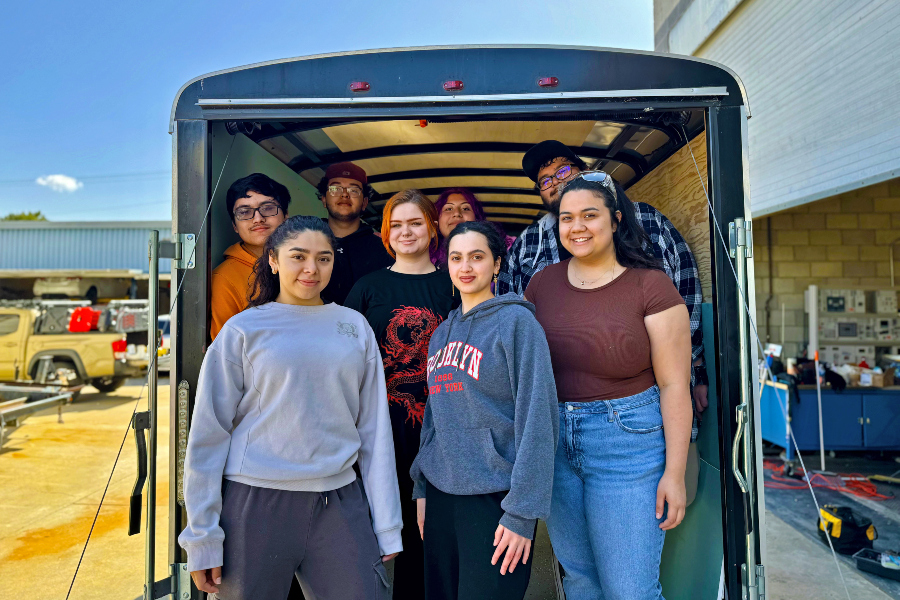 students stand inside a trailer during a hands-on project at citrus college