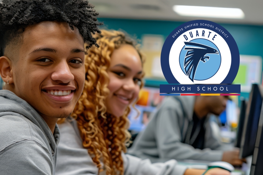 duarte high school students smile in a classroom with the duarte high school logo displayed above them