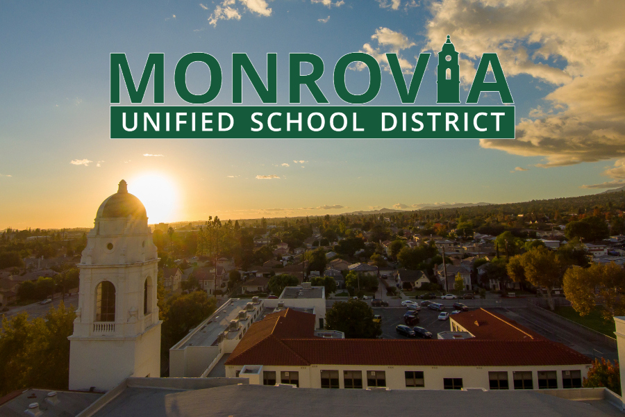 aerial view of monrovia high school buildings and the surrounding community at sunset with the district logo displayed above