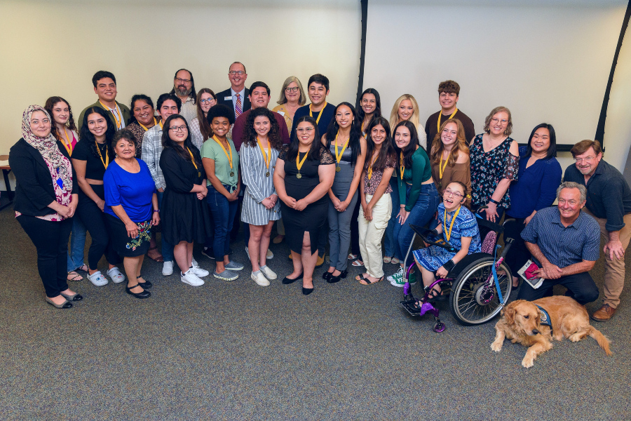 group of honors students with college administrators