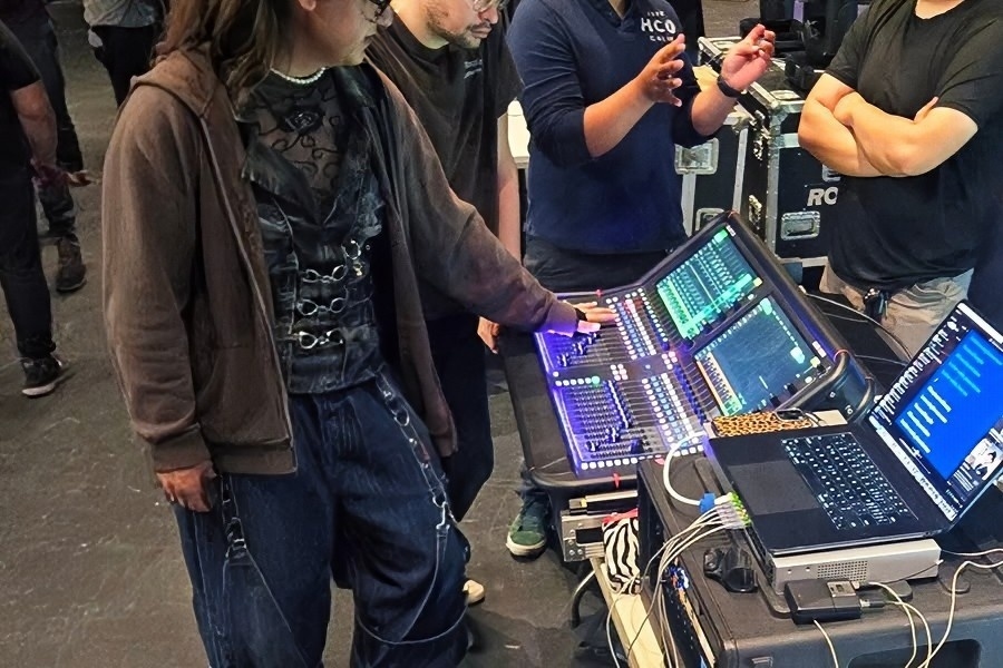students explore theater production technology inside the haugh performing arts center, gathered around lighting and control equipment during a citrus college campus visit