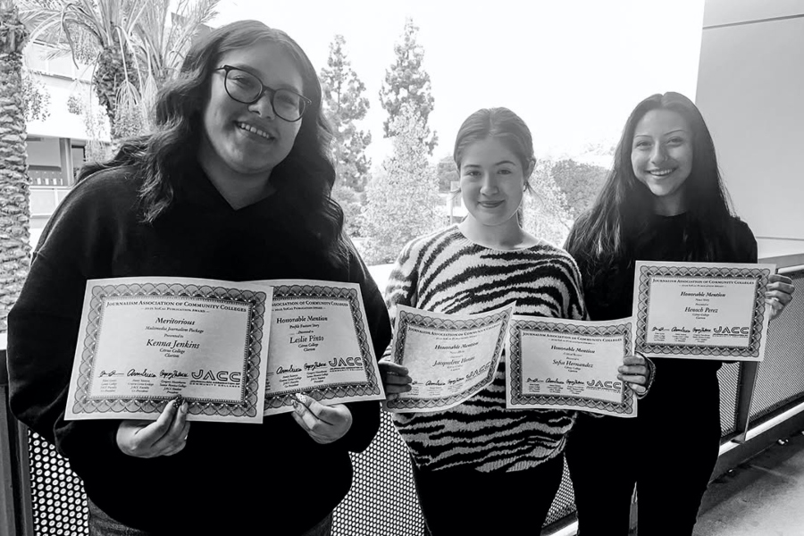 three citrus college journalism students pose on outdoor balcony, holding certificates from the journalism association of community colleges socal regional conference