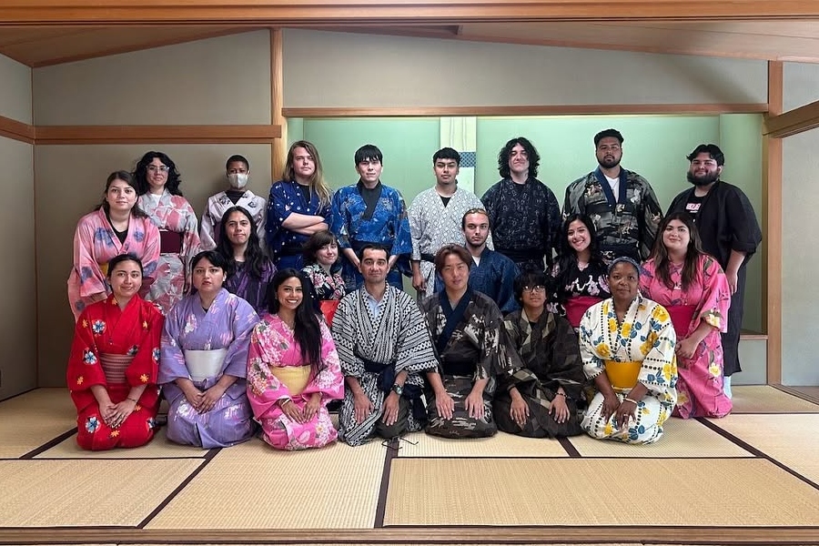 citrus college study abroad students and instructors pose together in a traditional japanese room with tatami mats, many wearing colorful yukata and kimono-style robes during a cultural activity in japan