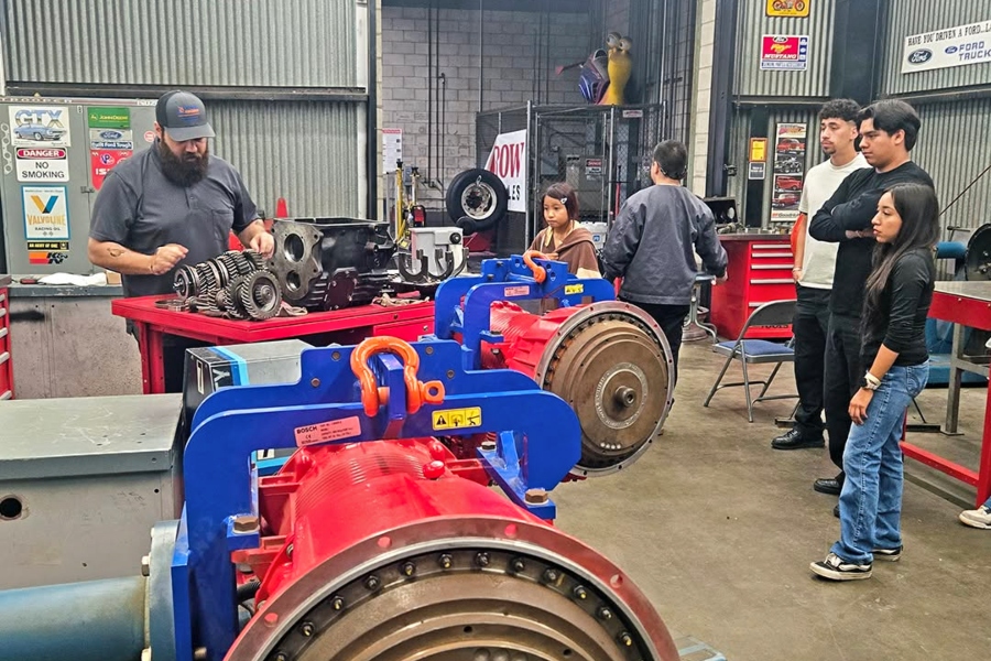 faculty spencer boldt demonstrates automotive equipment as nogales high school students observe inside a citrus college auto shop
