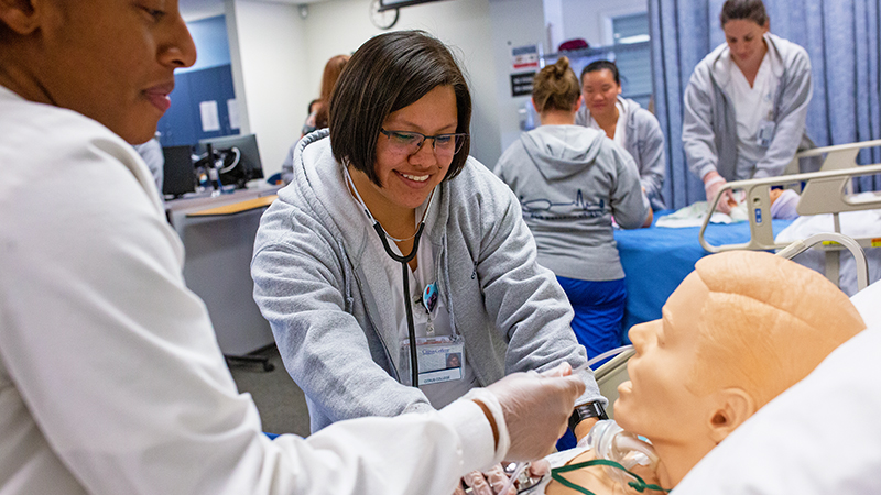 ADN students using medical training manikins in their classroom