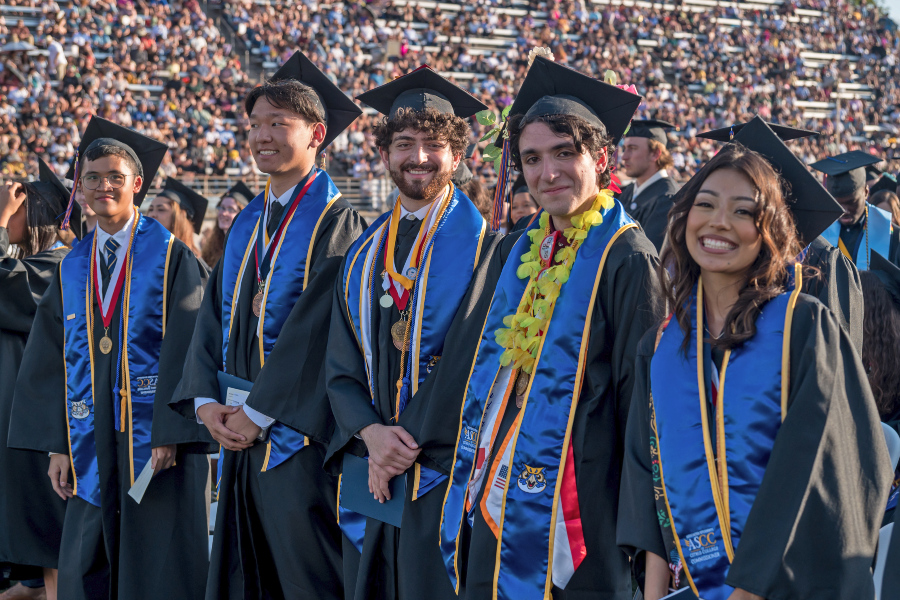 honors graduates in full regalia at the 2024 graduation ceremony