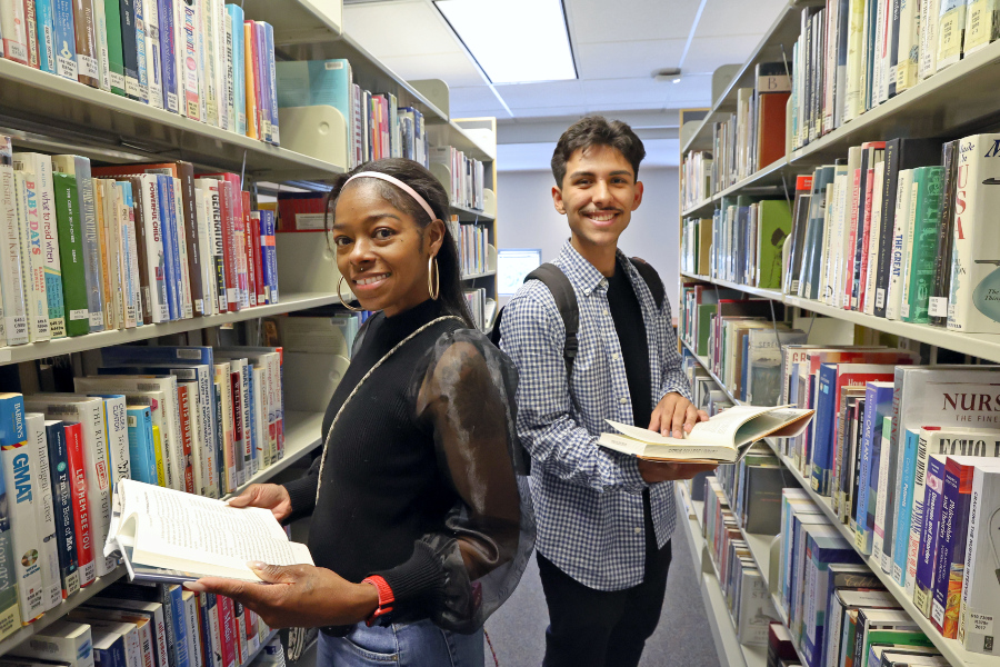 two students looking for books in the racks at the Citrus College Library