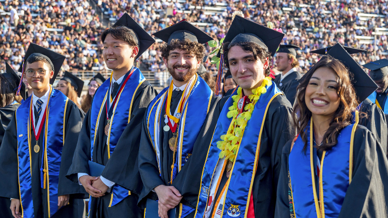 honors graduates in full regalia at the 2024 graduation ceremony