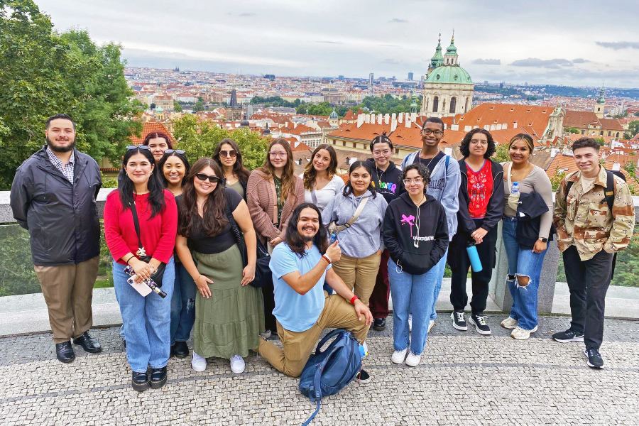 citrus college study abroad students pose together above the historic city skyline in prague