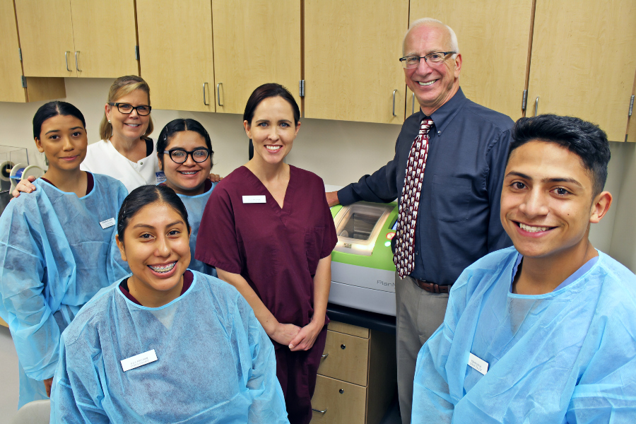 citrus college dental assisting students and faculty pose with donor richard cohrs beside the donated cad/cam dental system