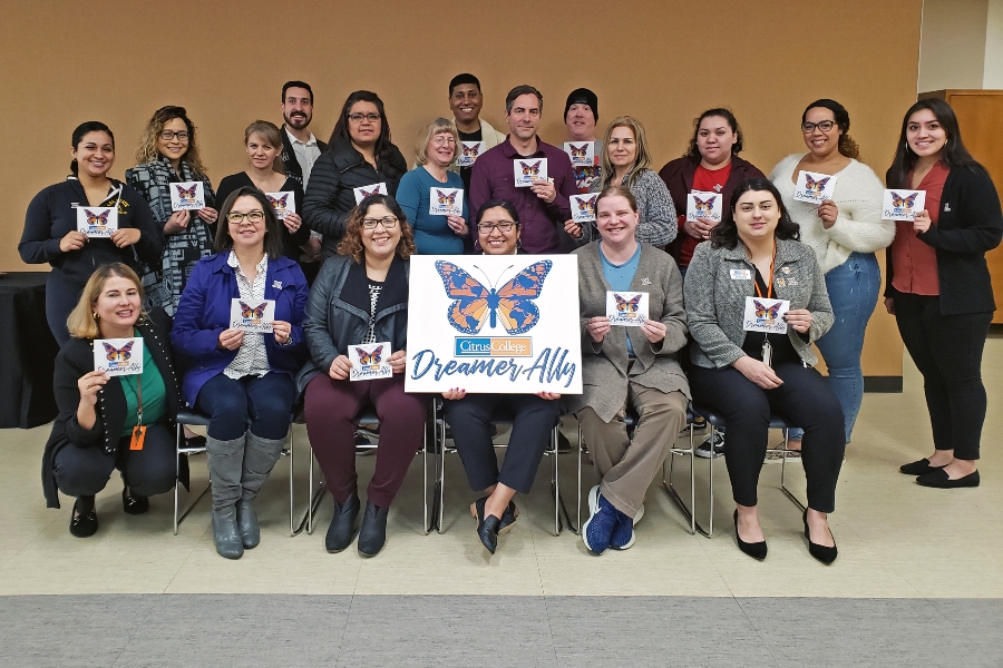 citrus college employees and students pose together holding dreamer ally signs with a large citrus college dreamer ally poster at center