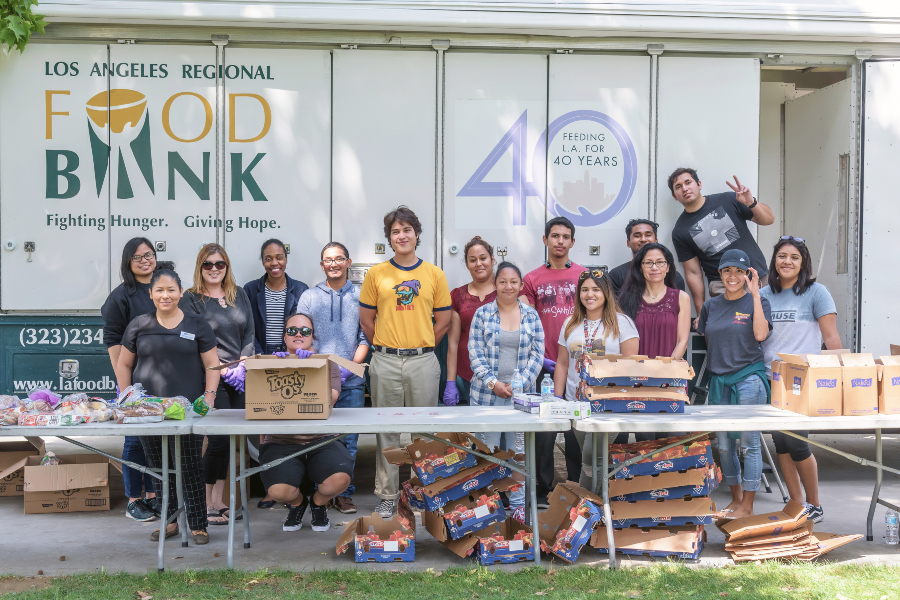 volunteers distributing food in front of a Los Angeles Regional Food Bank truck on campus