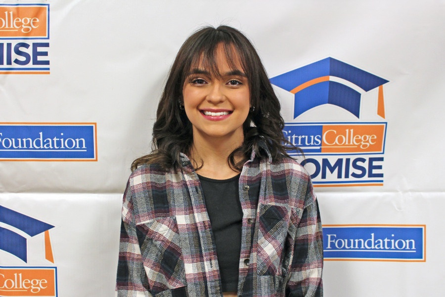 student standing in front of Citrus College Promise and Foundation backdrop