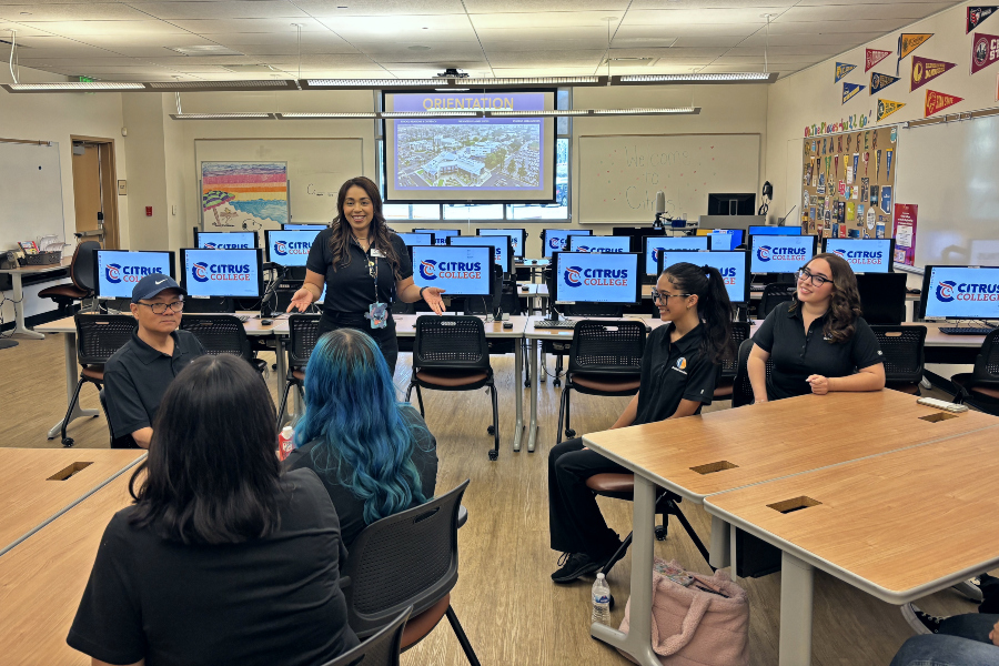 welcome center staff member leads an orientation for student ambassadors seated in the welcome center computer lab