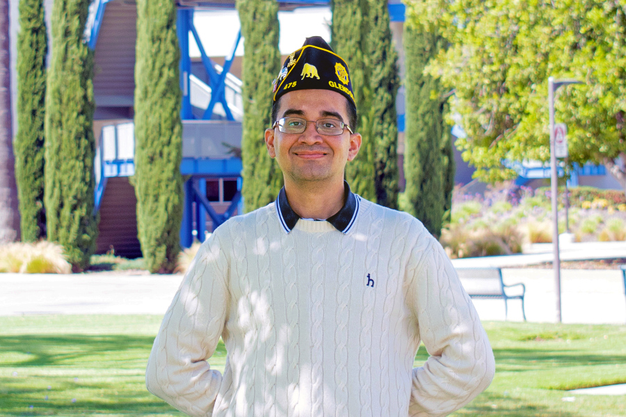 Hector Pimienta Jr. standing on campus with the ED Building in the background