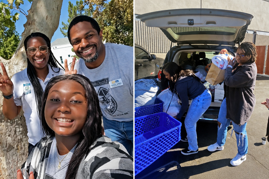 three people smile for a selfie while others unload donated items from the back of a vehicle during a community clothing drive