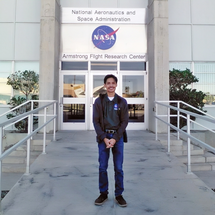 Matthew Levitt standing in front of NASA's Armstrong Flight Research Center 