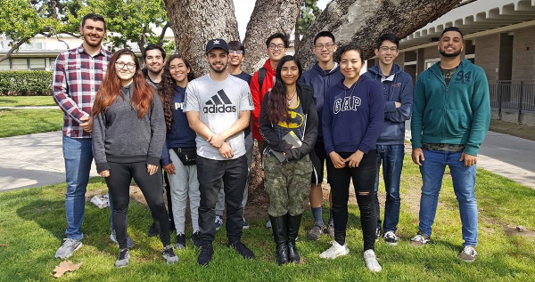 rocket owls students pose together beneath a large tree on the citrus college campus