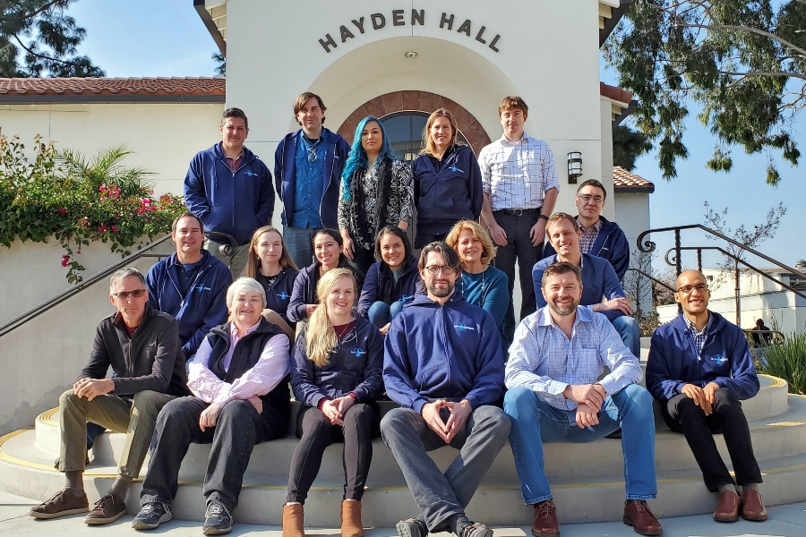 seventeen invader project researchers and participants pose together outside hayden hall at citrus college