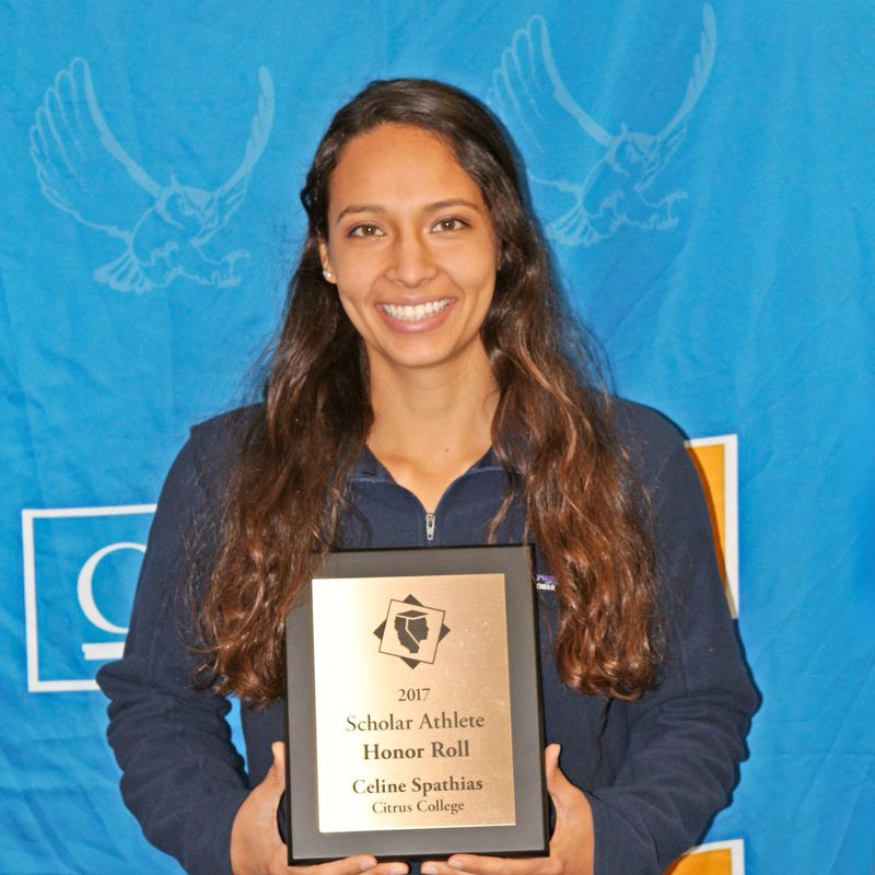 student-athlete smiles while holding a 2017 scholar athlete honor roll plaque in front of a citrus college backdrop